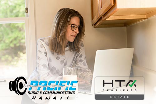 Woman working in the kitchen with a silver computer