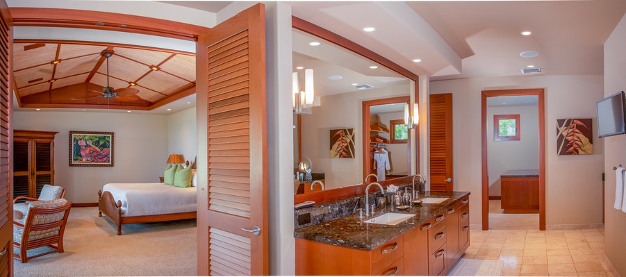 dual view of a primary bedroom and bathroom with recessed Lutron lighting and wood finishes.