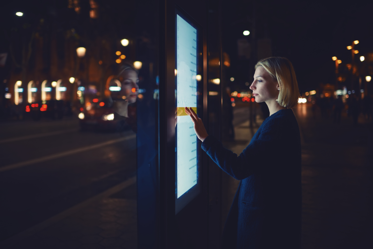  Image is of a person selecting something on a TV touch screen.