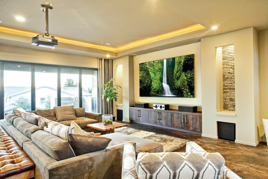 image is of a smart home living room with a flat screen TV mounted on the wall.